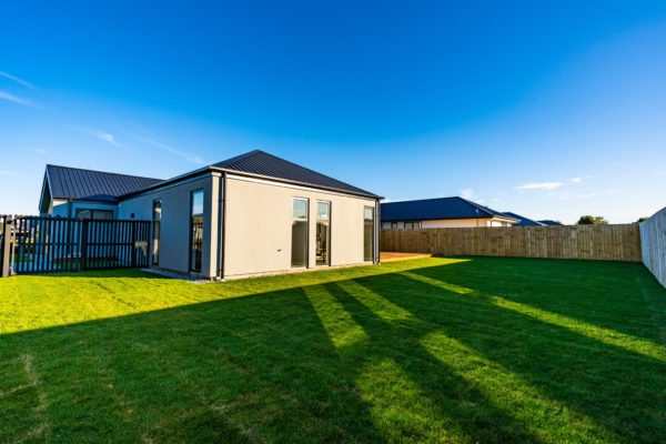 Forbes Residential Two Roads new build Canterbury turnkey home side view from grassy backyard
